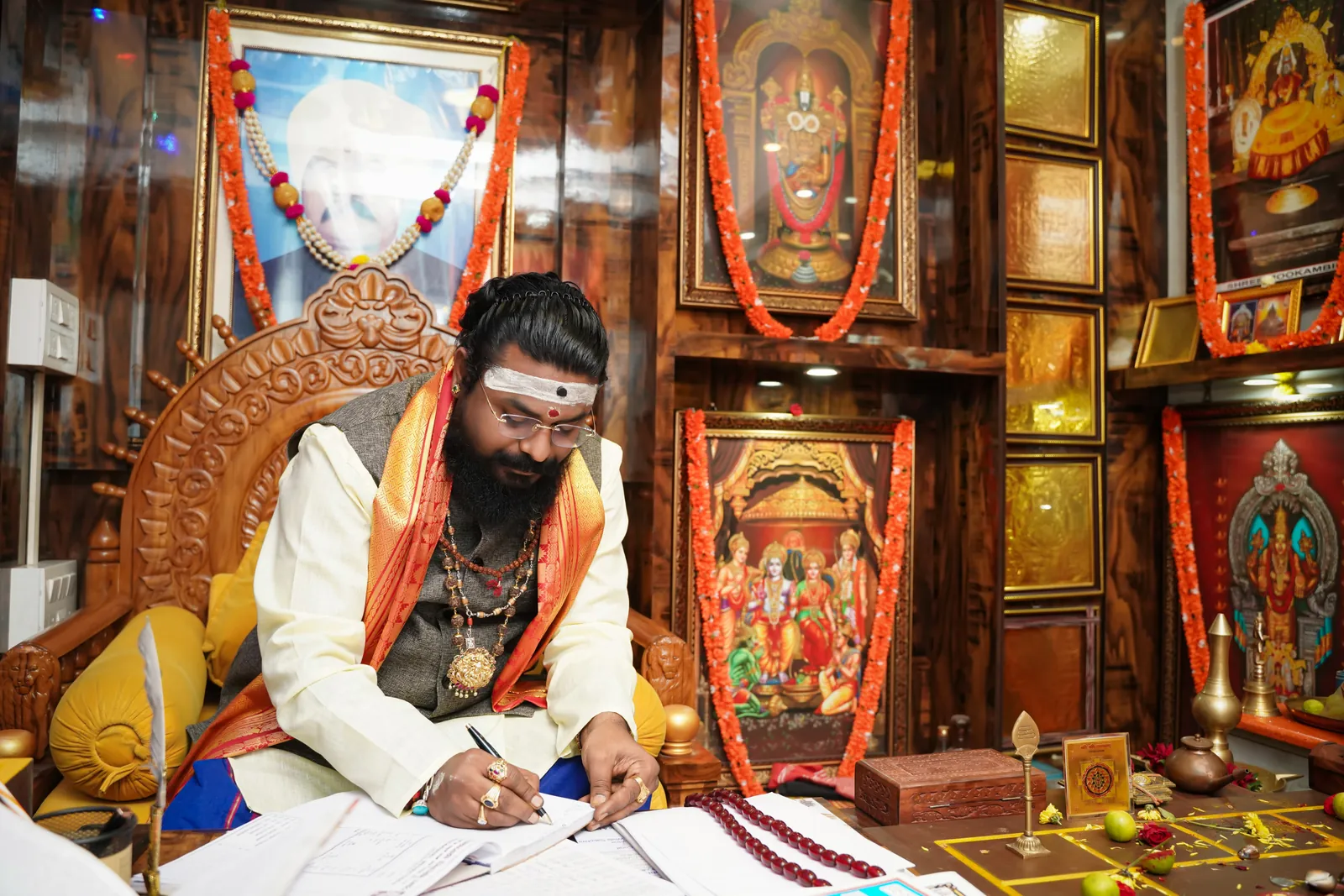 Arun Sharma Guruji casting a chart at his desk